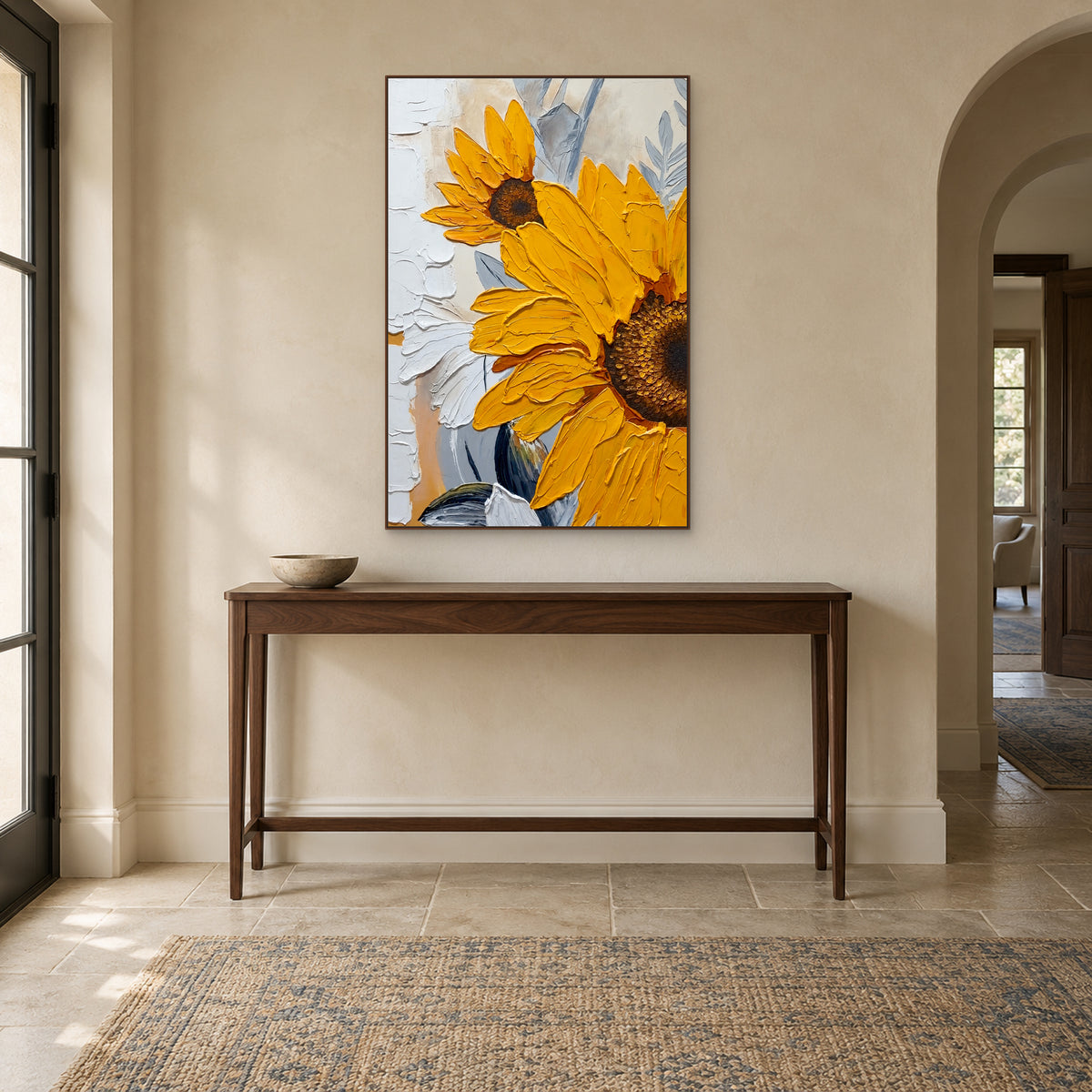 Sunflower painting in a walnut-tone frame above a slim wooden console in a cream entryway