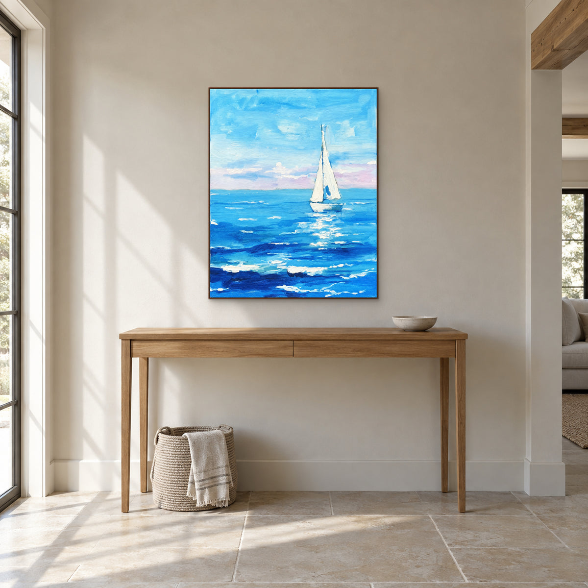 White sailboat seascape in a walnut-look frame centred above an oak-look entryway console.