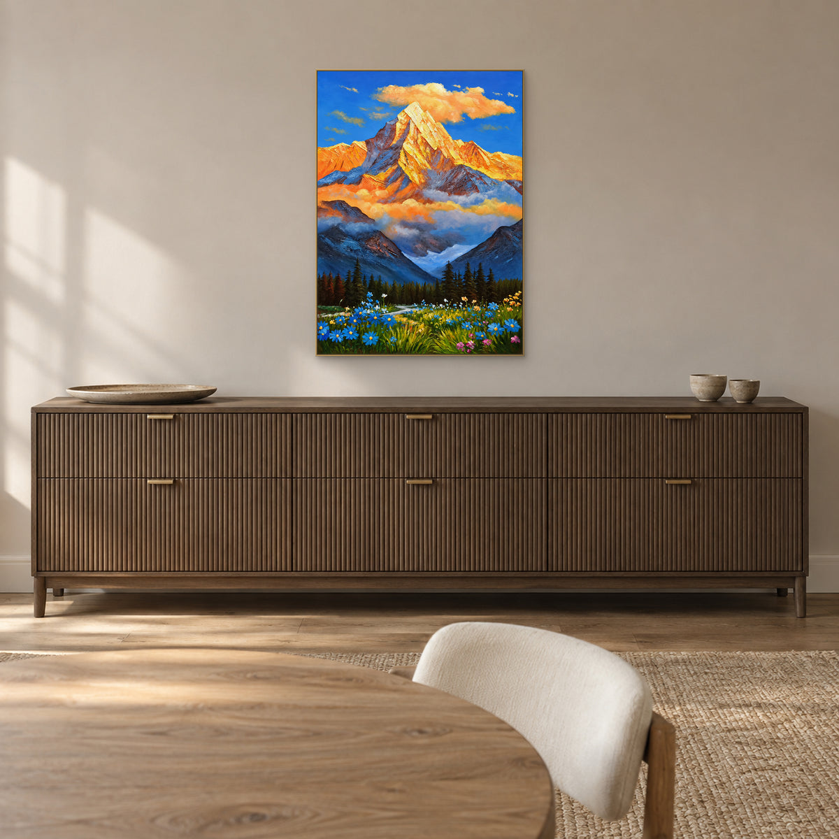 Golden peak and blue wildflowers in a champagne-tone frame above a fluted dark-wood dining room sideboard