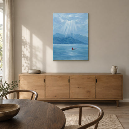 Blue mountain lake artwork in a champagne-toned frame above a wooden dining-room sideboard