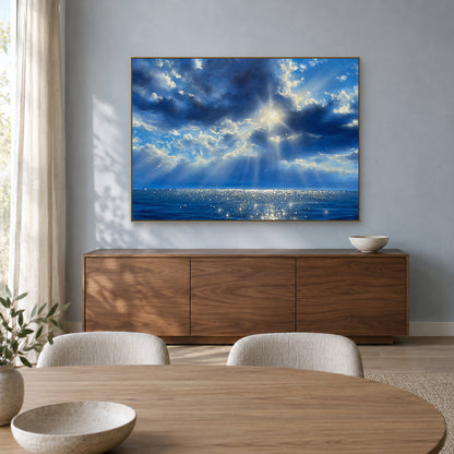 Blue ocean and cloud painting in a champagne-coloured frame above a walnut sideboard in a dining room.