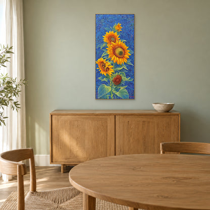 Champagne-framed sunflower painting above a wooden sideboard against a muted green dining-room wall