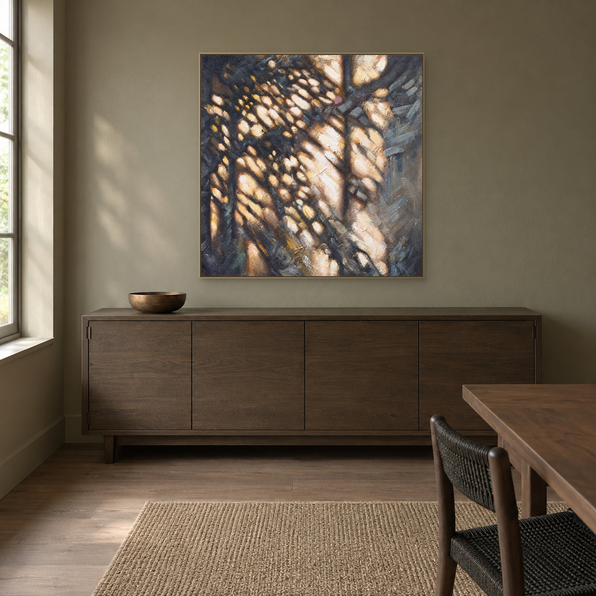 Square charcoal and ivory abstract in a champagne floating frame above a dining-room sideboard