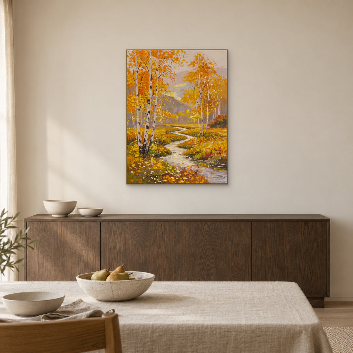 Autumn birch painting in a champagne-toned frame over a dining-room sideboard