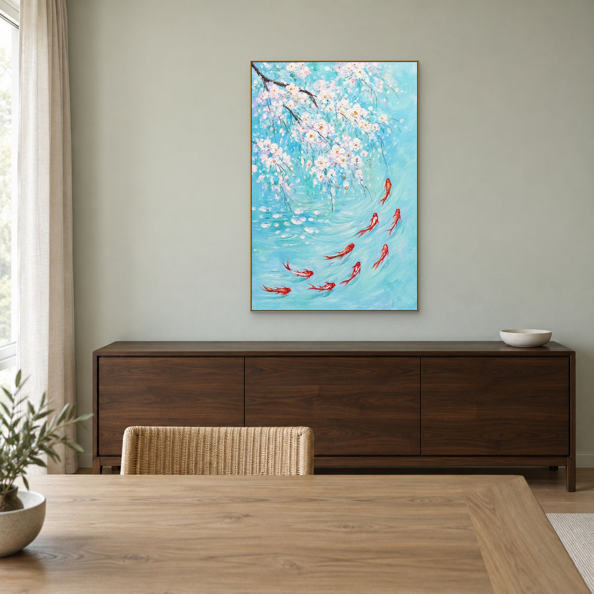 Koi Beneath White Blossoms in a champagne-coloured floating frame above a dark walnut sideboard against a pale sage dining-room wall.
