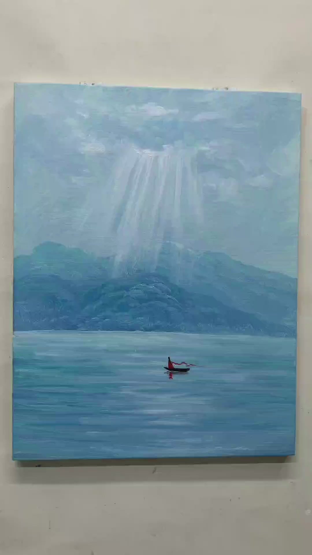 Painting process showing light rays, blue mountain ridges, lake strokes and a red figure in a small boat, followed by a framed artwork illustration