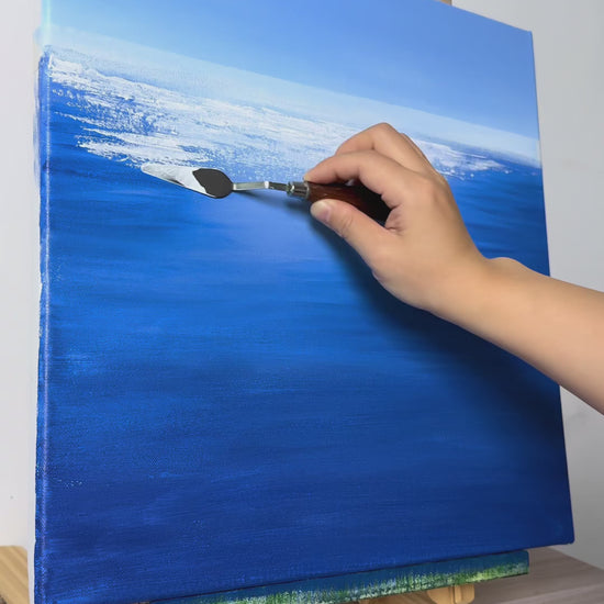 Hand-painting white water reflections and green grasses, followed by the finished blue seascape on an easel