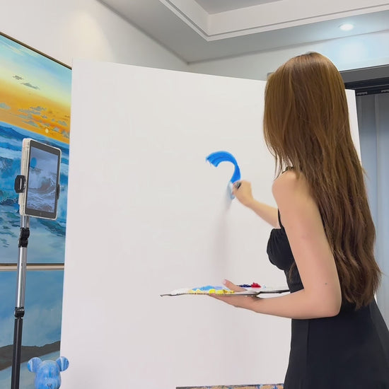 Painting a blue wave from its first curved strokes to the finished white spray and sea foam