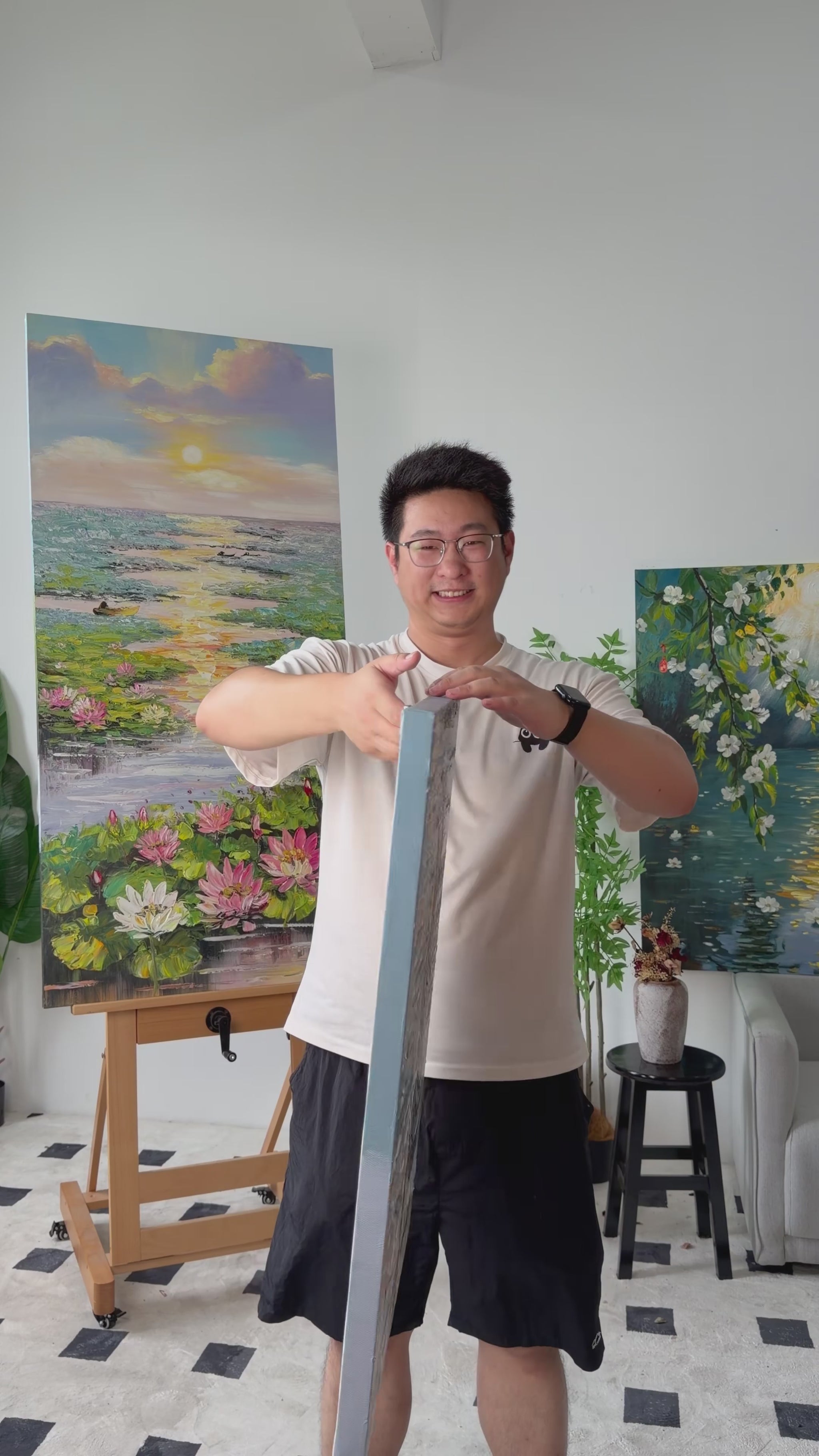 Studio video turning the painting from a narrow side view to a full view of a woman in a flowing dress beside the sea