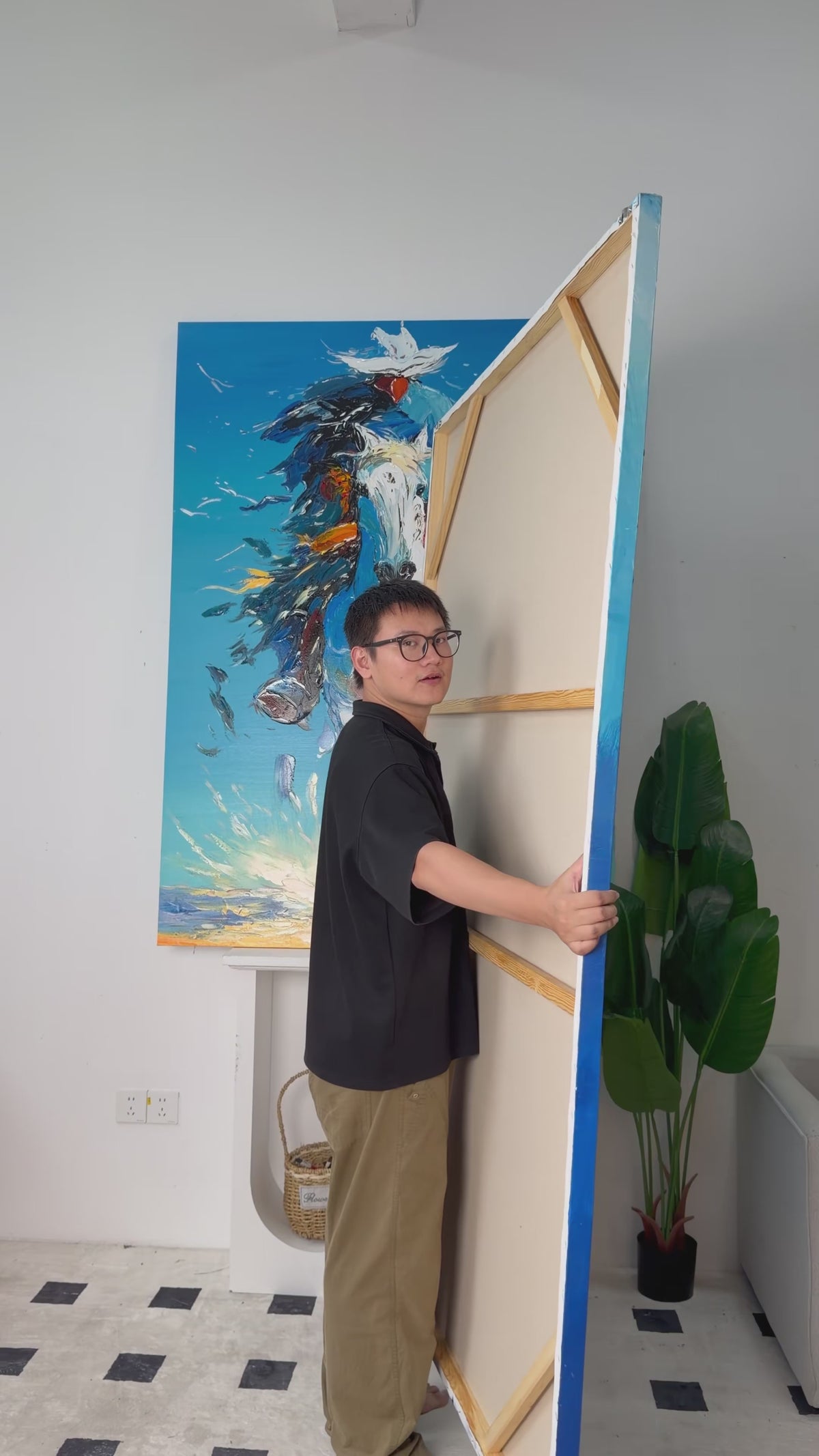 Real studio video showing the back and turning the painting to reveal a blue fish school surrounding two divers